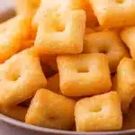 Homemade Cheez-Its in a bowl on rustic table